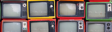 A wall of old vintage tube televisions