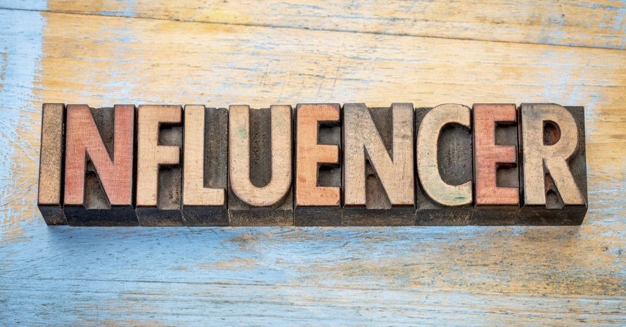 influencer - word abstract in vintage letterpress wood type printing blocks